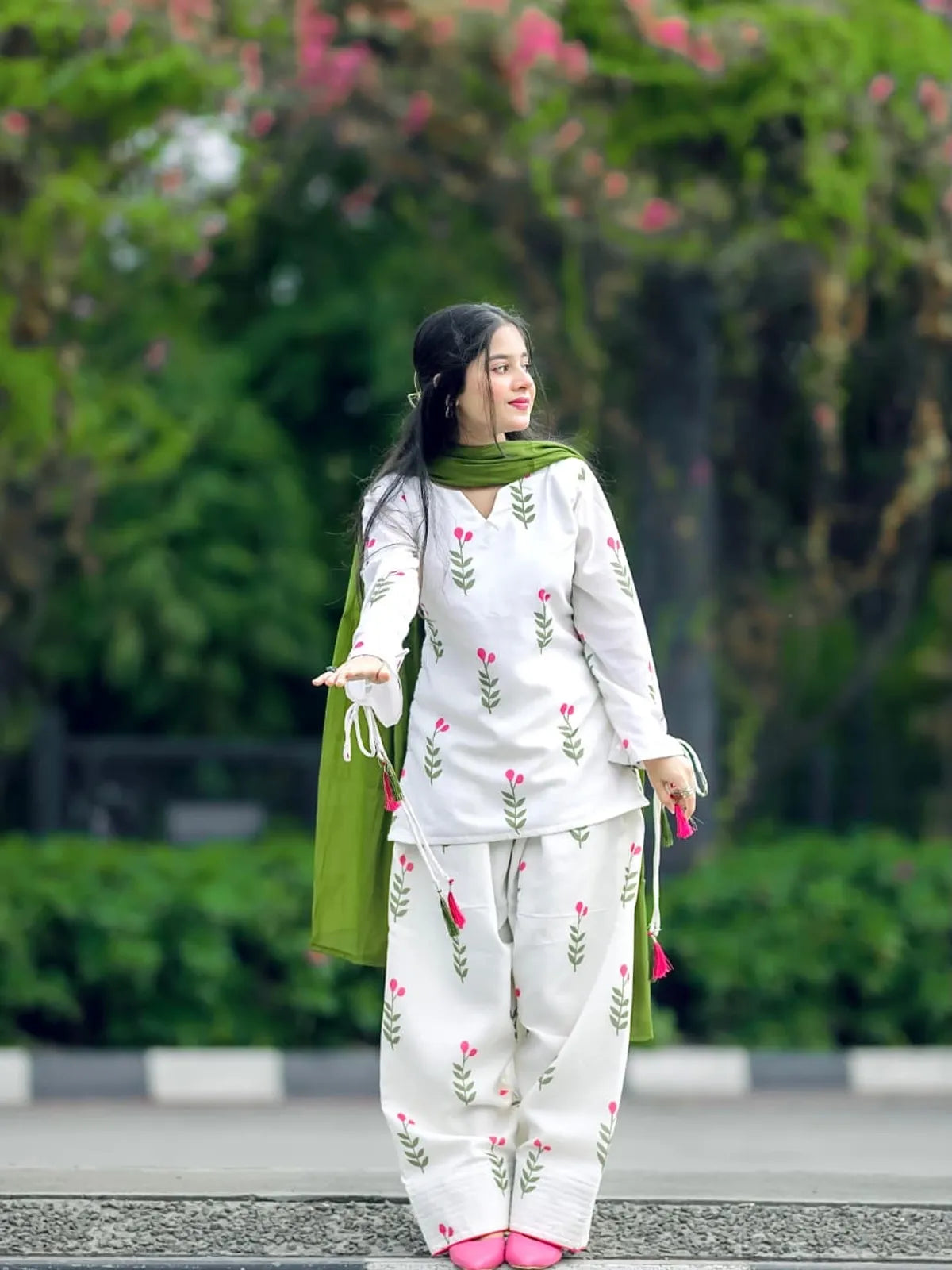 Side pose view of white floral embroidered Dhanak 3 piece suit with green dupatta