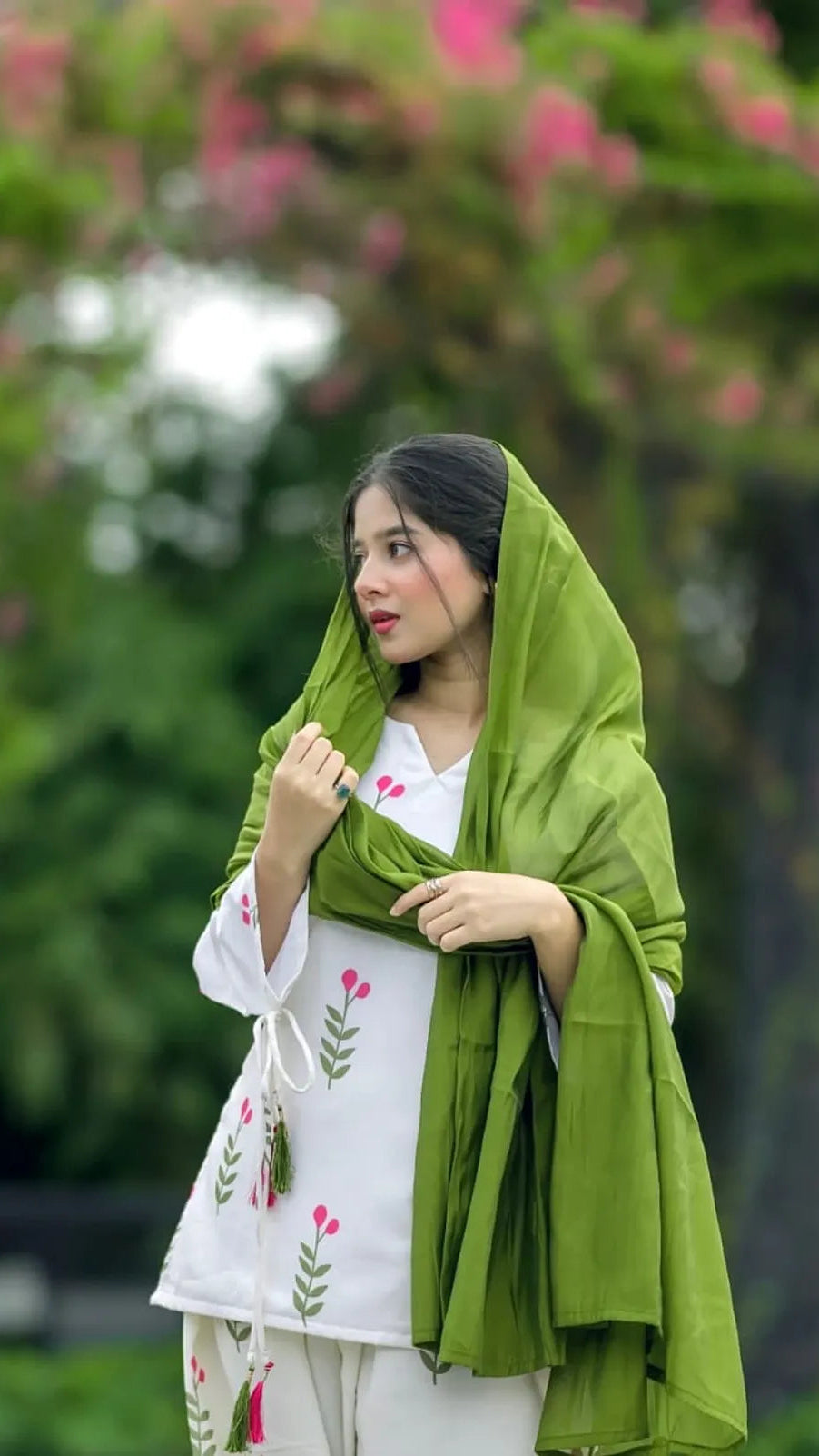 Close up model shot with green dupatta styling on white embroidered Dhanak suit